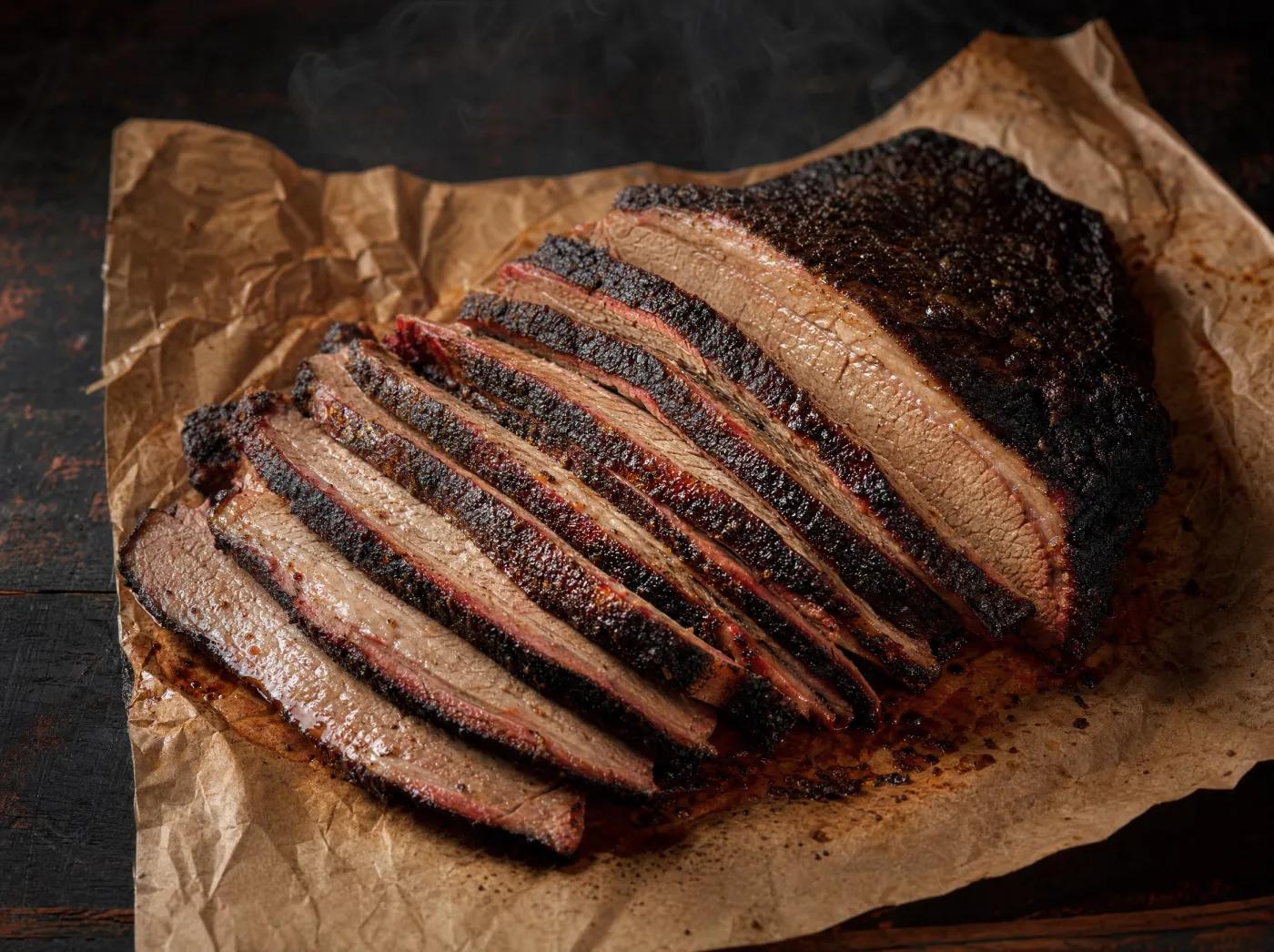 Sliced smoked brisket with pepper bark and smoke ring at One's BBQ Lavon TX